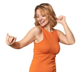 Blonde middle-aged Caucasian woman in studio dancing and having fun.