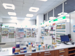 Defocused view inside of pharmacy with the seller counter, computer and cash register against...