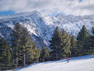 View to the snowy slope with a freeride skier having fun at Bansko ski resort in Bulgaria