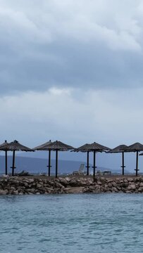 Powerful waves crashing the coast of Njivice, Croatia one day after Storm Ciar&aacute;n smashed into Krk Island. Beautiful disquiet blue sea surface on a rainy day. Cinematic water splashes.