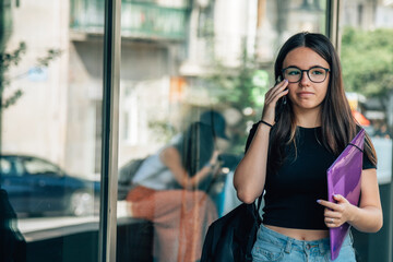 girl student with phone outside school
