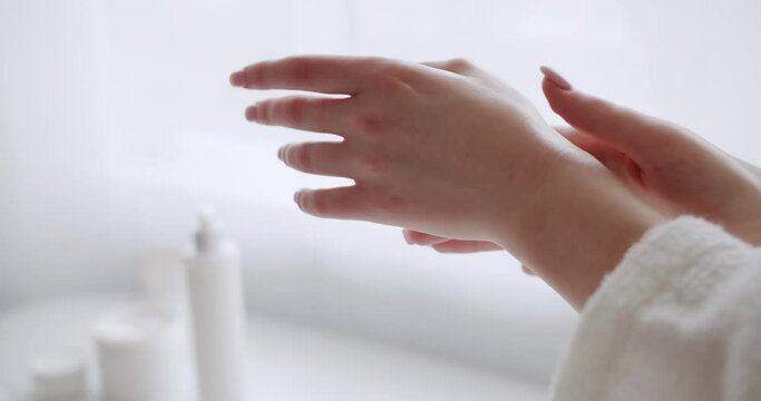 Young beautiful woman applying body lotion and skincare cream, Beauty Creams, Clean Natural. Anti aging or glowing skin. Young woman applying rejuvenating serum on her hand and body.