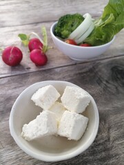Fresh vegetable salad red radish and cheese in the bowl