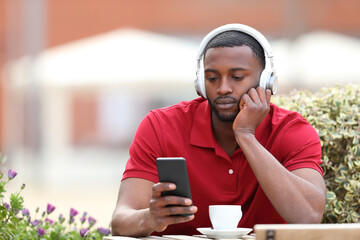 Black man listening to music in a coffee shop