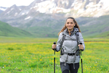 Front view of a happy hiker trekking in nature