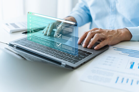 Businessperson online working on laptop with digital document form. Business quality of product or service and financial performance checklist. Project approval or questionaire survey concept.
