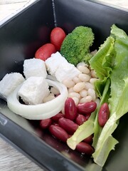 Fresh vegetable salad broccoli red beans white beans chickpeas cheese