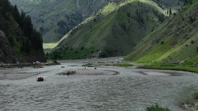 A drone pans out to frame a raft floating in Naran&rsquo;s waters against a dramatic mountainous landscape, blending adventure with nature