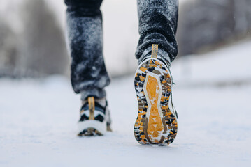 man runs on winter path