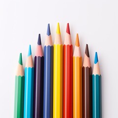 Fototapeta premium Stack of vibrant colored pencils on a white sheet of paper