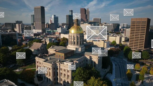 Capitol building of Georgia in downtown Atlanta. Aerial orbit with skyline and envelopes animation. Voting and mail in ballot theme.