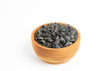 black sunflower seeds in a small wooden cup