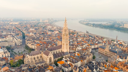 Antwerp, Belgium. Spire with the clock of the Cathedral of Our Lady (Antwerp). Historical center of Antwerp. City is located on river Scheldt (Escaut). Summer morning, Aerial View - obrazy, fototapety, plakaty