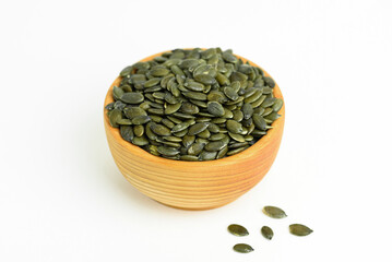 pumpkin seeds in a small wooden cup