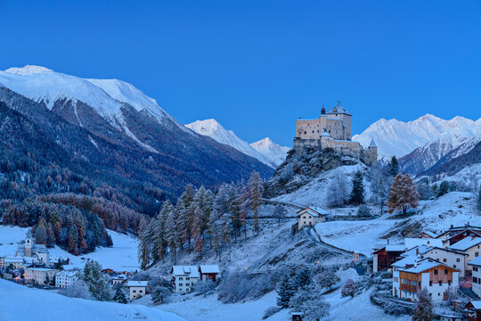 Tarasp Castle near houses and snowcapped Sesvenna Alps, Tarasp, Lower Engadine, Engadine, Grisons, Switzerland