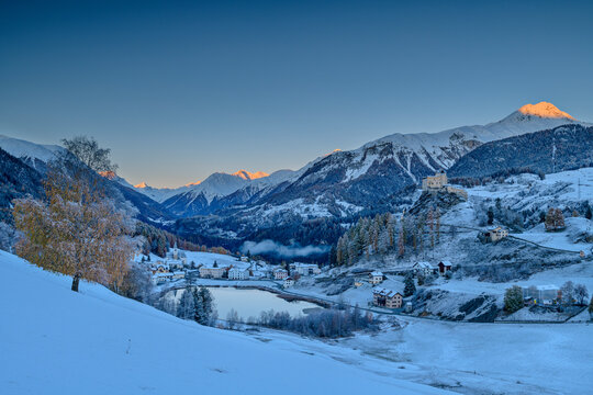 Castle and lake near Silvretta Alps at dawn, Lower Engadine, Engadine, Grisons, Switzerland