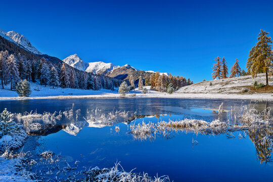 Lake Lai Nair with reflection near snowcapped Sesvenna Alps, Tarasp, Lower Engadine, Engadine, Grisons, Switzerland