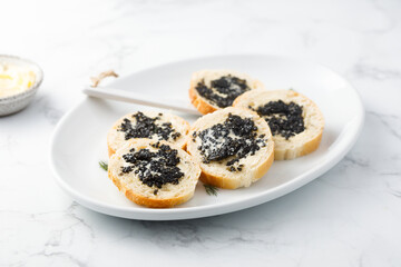 Black caviar on fresh baguette bread