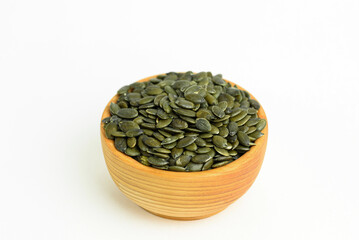 pumpkin seeds in a small wooden cup
