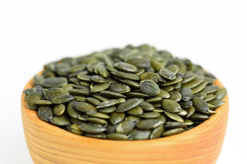 pumpkin seeds in a small wooden cup