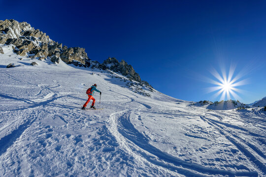 Mature woman back country skiing on Gruenstein at sunny day, Mieming Range, Tyrol, Austria