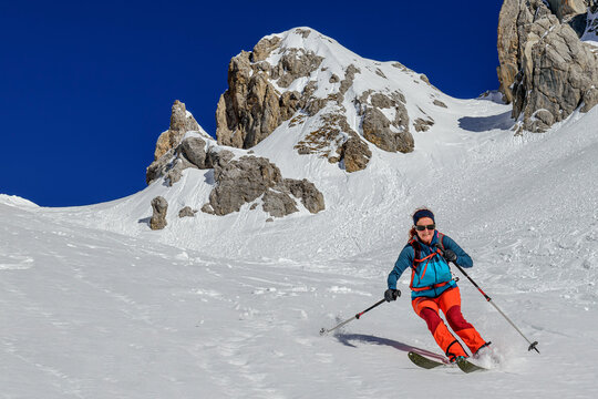 Woman back country skiing downhill on Gruensteinscharte at Grunstein, Mieming Range, Tyrol, Austria