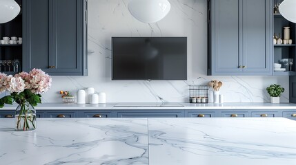 White marble countertop in a kitchen interior with blue cabinets and flat screen television on empty shelf