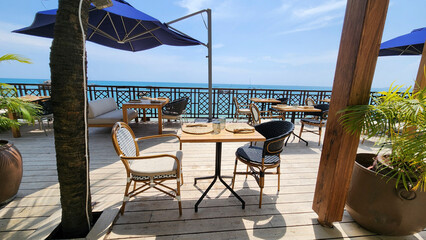 Tables in a restaurant near the beach
