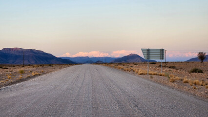 Empty road in desert in sunset