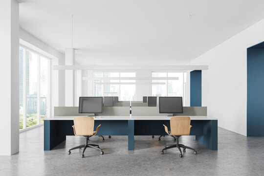 White coworking office interior with blue tables