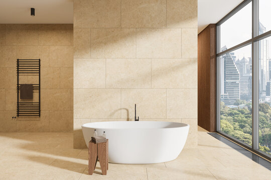 Beige hotel bathroom interior with tub and rail ladder, empty wall and window