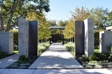 A contemporary gate framed by sleek concrete pillars and minimalist landscaping.