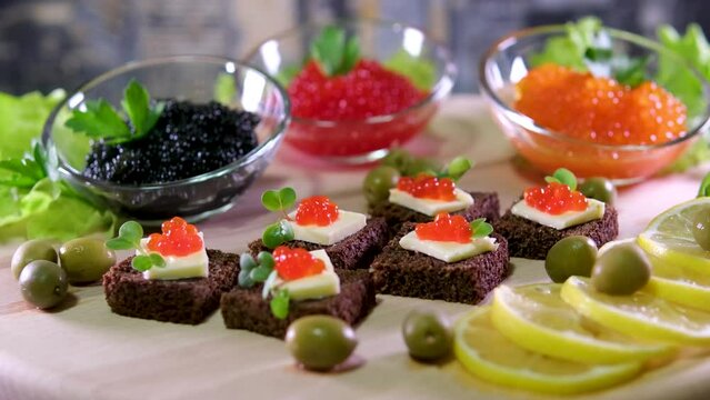 Sandwiches with red and black caviar on white and Borodino bread
