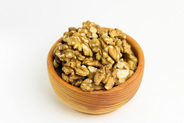 brown walnuts in wooden cup