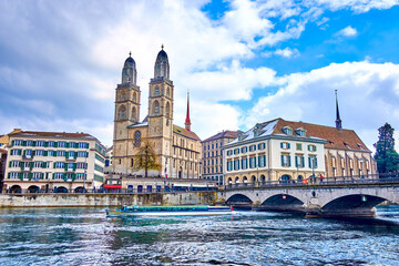 Limmat river and Munsterbrucke bridge with Grossmunster, houses on the river's bank, Zurich, Switzerland