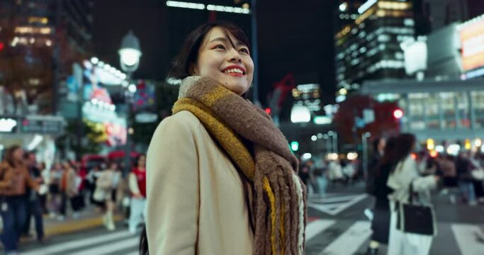 Night, walking and young woman in the city for exploring on vacation, adventure or holiday. Happy, travel and beautiful Japanese female person for sightseeing on weekend trip in urban Tokyo town.