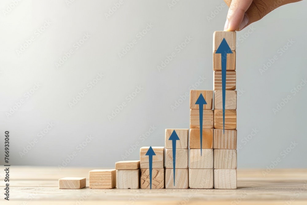 Aufkleber a hand is placing blocks on top of each other, creating a staircase