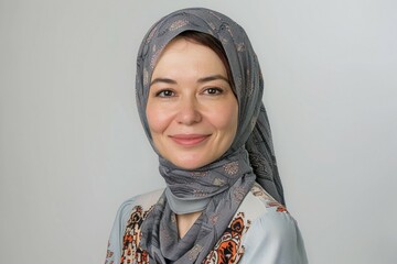 A woman wearing a scarf and smiling