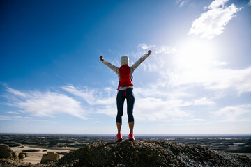 Successful woman trail runner open arms on sand desert dunes © lzf