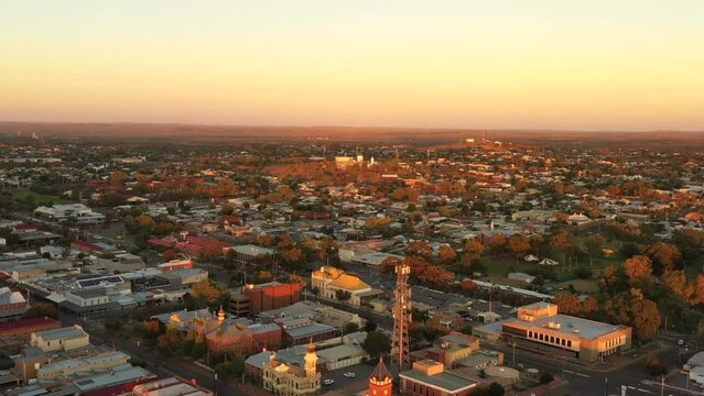 Broken Hill city skyline in aerial sunrise landing over streets and roof tops as 4k.

