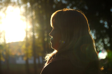 woman gazes into the horizon, embodying themes of mental well-being, optimism, and contentment. Blurred. Out of focus