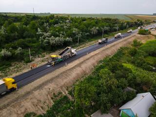 Chernivtsi, Ukraine-07.19.2021: Road equipment and road workers repairing the road