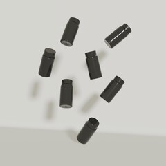 A photo of black vials floating in zero gravity against a white wall.