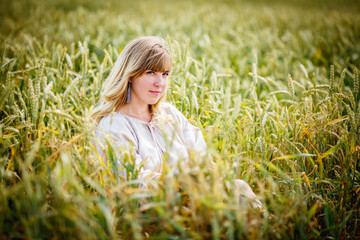 beautiful girl in a linen dress in a wheat field