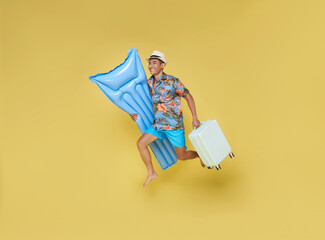 Full body young traveler tourist asian man in summer clothes hat hold suitcase inflatable mattress...
