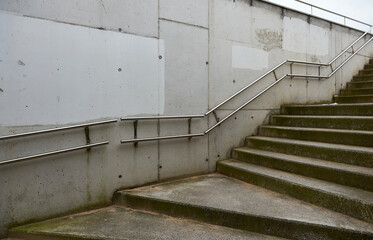 stairs and concrete wall with stainless steel handrail