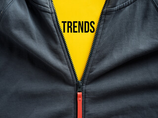 Opened zipper of a hoodie showing the word trends on a tag. Fashion trends in casual sportwear clothing.