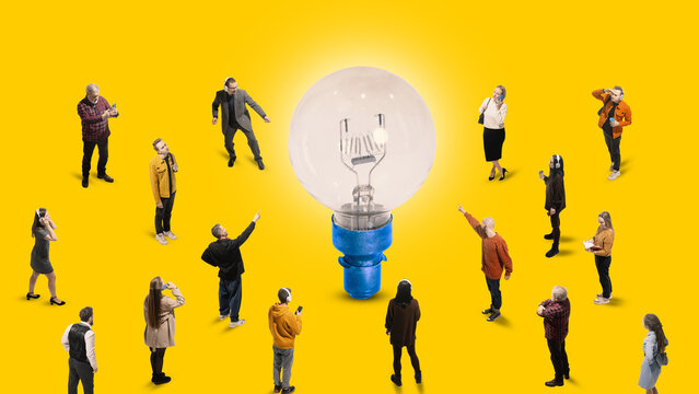 Contemporary art collage. Young people, workers and students stands in front of huge light bulb against yellow background. Ideas and creativity. Concept of business, work and education, startup. Ad