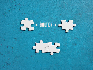 The word solution with puzzle pieces on blue background.