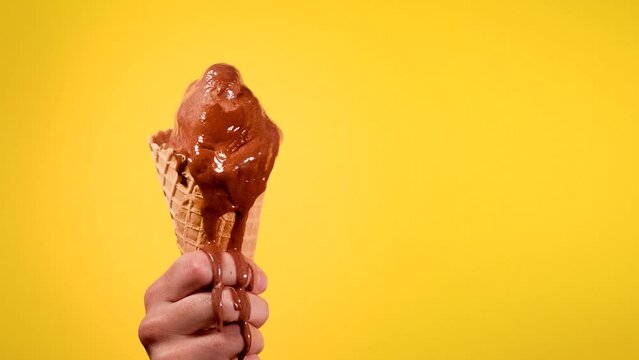 Melting Ice Cream Cone Held by a Hand